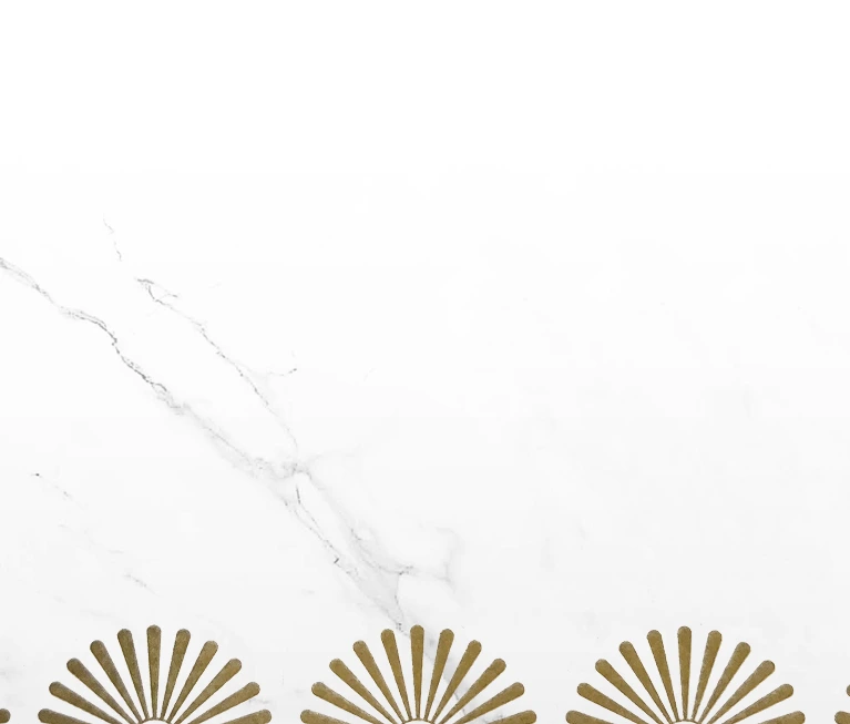 White marble background with a row of gold fan-shaped decorative elements along the bottom edge.
